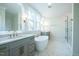 Luxurious bathroom with dual sinks, a freestanding tub, and a glass-enclosed shower at 3000 Eden Harbor Ct, Raleigh, NC 27613