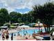 Seven Oaks pool area featuring families enjoying a relaxing summer day in the water at 3000 Eden Harbor Ct, Raleigh, NC 27613