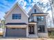 Charming two-story home with a gray exterior, black window frames, and a two car garage at 3000 Eden Harbor Ct, Raleigh, NC 27613