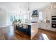 Modern kitchen features a large waterfall island, stainless steel appliances, and hardwood floors at 3000 Eden Harbor Ct, Raleigh, NC 27613