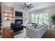 Bright living room with a black fireplace, built in shelving, and a sliding glass door to the backyard at 3000 Eden Harbor Ct, Raleigh, NC 27613