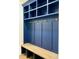 Stylish mudroom with navy blue cabinetry, gold hardware, and a built-in bench at 3000 Eden Harbor Ct, Raleigh, NC 27613
