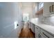 Long white butler's pantry with plenty of counter space and storage with view into the kitchen at 3000 Eden Harbor Ct, Raleigh, NC 27613