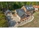 Aerial view of a brick home with a spacious yard, a detached garage, and meticulous landscaping at 3001 Greystone Dr, Rocky Mount, NC 27804