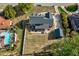 Aerial view of a home with a spacious backyard, detached garage, patio, and neatly kept landscaping at 3001 Greystone Dr, Rocky Mount, NC 27804