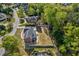 Aerial view of a brick home with lush landscaping, a detached garage, and a private backyard oasis at 3001 Greystone Dr, Rocky Mount, NC 27804