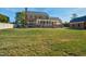 Large backyard with green lawn, a brick home, and an outdoor patio with seating and an umbrella at 3001 Greystone Dr, Rocky Mount, NC 27804