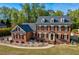 Traditional two-story brick home with a manicured lawn and mature trees at 3001 Greystone Dr, Rocky Mount, NC 27804