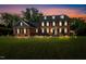 Two-story brick home with black shutters at twilight, with a manicured lawn at 3001 Greystone Dr, Rocky Mount, NC 27804