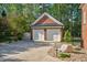Detached garage with two white doors, a brick facade, and landscaped with decorative stones and lighting at 3001 Greystone Dr, Rocky Mount, NC 27804