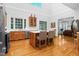 Well-lit kitchen boasts hardwood floors, stainless steel appliances, and an island with seating at 3001 Greystone Dr, Rocky Mount, NC 27804