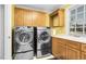 Well-equipped laundry room features updated washer and dryer units, sink, and storage cabinets at 3001 Greystone Dr, Rocky Mount, NC 27804