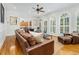 Bright living room with hardwood floors, ceiling fan, and large windows with plantation shutters at 3001 Greystone Dr, Rocky Mount, NC 27804