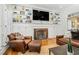 Cozy living room features a fireplace, built-in shelving, and comfortable leather seating at 3001 Greystone Dr, Rocky Mount, NC 27804