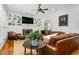 Cozy living room with custom built-ins, fireplace, and a comfortable leather sectional sofa at 3001 Greystone Dr, Rocky Mount, NC 27804