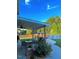 Backyard patio showcasing an outdoor dining area, flower garden, and above-ground pool for relaxation at 3098 Creek Point Rd, Graham, NC 27253