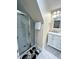 Bathroom with a sleek glass shower, white vanity with marble top, and modern fixtures at 3098 Creek Point Rd, Graham, NC 27253
