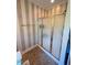 Bathroom with a glass enclosed shower and decorative wall paper at 3098 Creek Point Rd, Graham, NC 27253