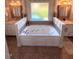 Spa bathroom featuring a jacuzzi tub flanked by two sinks with vanities at 3098 Creek Point Rd, Graham, NC 27253