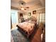 Bedroom featuring a floral bedspread, ceiling fan, and hardwood floors at 3098 Creek Point Rd, Graham, NC 27253