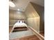 Comfortable bedroom with neutral tones, a cozy bed, and a decorative area rug on wood floors at 3098 Creek Point Rd, Graham, NC 27253