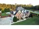 Charming brick home featuring manicured lawn, driveway, attached garage, and attractive landscaping at 3098 Creek Point Rd, Graham, NC 27253