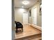 Hallway with seating, hardwood flooring, and neutral paint at 3098 Creek Point Rd, Graham, NC 27253