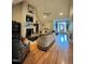 Spacious living room featuring hardwood floors, a fireplace, and elegant furnishings at 3098 Creek Point Rd, Graham, NC 27253