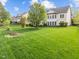 Spacious backyard with a large tree and well-manicured lawn, providing a peaceful outdoor setting at 312 Alliance Cir, Cary, NC 27519