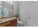 Elegant half bathroom features granite countertop, wood cabinets, and modern fixtures at 312 Alliance Cir, Cary, NC 27519