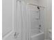 Full bathroom with tub and shower featuring white and gray patterned curtain at 312 Alliance Cir, Cary, NC 27519