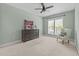 Light-filled bedroom features plush carpeting, ceiling fan, and classic dresser at 312 Alliance Cir, Cary, NC 27519