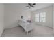 Cozy bedroom featuring a ceiling fan, neutral carpet, and a bright window with a pleasant outdoor view at 312 Alliance Cir, Cary, NC 27519