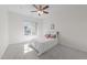 Bright bedroom features a cozy bed with a ceiling fan and a view to the outdoors at 312 Alliance Cir, Cary, NC 27519