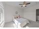 Bright bedroom features a cozy bed with a ceiling fan and a view to the outdoors at 312 Alliance Cir, Cary, NC 27519