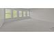 Expansive carpeted bonus room with plenty of natural light from multiple windows at 312 Alliance Cir, Cary, NC 27519