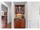 Butlers pantry has granite countertop, wooden cabinets, and stylish decor at 312 Alliance Cir, Cary, NC 27519