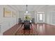 Classic dining room features hardwood floors, a modern chandelier, and decorative art at 312 Alliance Cir, Cary, NC 27519
