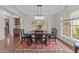 Elegant dining room with modern light fixture, dark wood furniture, and decorative rug at 312 Alliance Cir, Cary, NC 27519