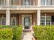 Close up of the front door with lush green bushes, brick walls and glass sidelights at 312 Alliance Cir, Cary, NC 27519