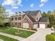 Lovely two-story brick home with a two-car garage, a basketball hoop, and a well-maintained lawn at 312 Alliance Cir, Cary, NC 27519
