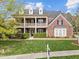 Beautiful two-story brick home with a charming double front porch and well-manicured lawn at 312 Alliance Cir, Cary, NC 27519
