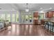 Open-concept kitchen features granite counters, stainless steel appliances and a seamless transition to a dining area at 312 Alliance Cir, Cary, NC 27519