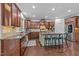 A modern kitchen featuring stainless steel appliances, granite countertops, and an island with barstool seating at 312 Alliance Cir, Cary, NC 27519
