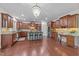 Spacious kitchen boasts hardwood floors, granite countertops, stainless steel appliances, and a charming breakfast bar at 312 Alliance Cir, Cary, NC 27519