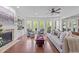 Spacious living room with fireplace, built-in shelving, large windows, and hardwood floors at 312 Alliance Cir, Cary, NC 27519