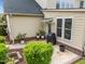 Outdoor patio area featuring brick accents, decorative plants, and a grill for outdoor entertaining at 312 Alliance Cir, Cary, NC 27519
