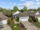 Aerial view of a home featuring manicured lawns and an attached garage, highlighting its serene setting at 320 Easton Grey Loop, Cary, NC 27519