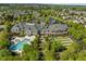Overhead view featuring a community clubhouse, swimming pool, and sports facilities nestled in a green landscape at 320 Easton Grey Loop, Cary, NC 27519