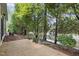 Relaxing back patio surrounded by mature trees and low-maintenance landscaping at 320 Easton Grey Loop, Cary, NC 27519
